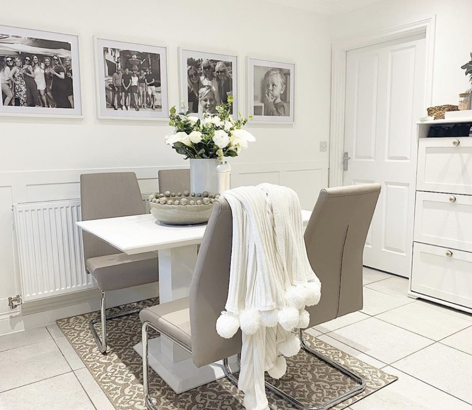 A modern white high gloss dining set used in a stylish white room