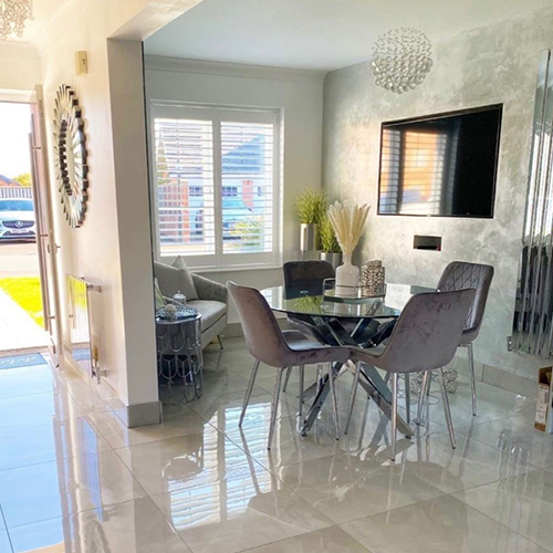 modern open plan living area with marble effect ceramic tile flooring and round glass dining table with chrome legs, ad 4 grey velvet dining chairs