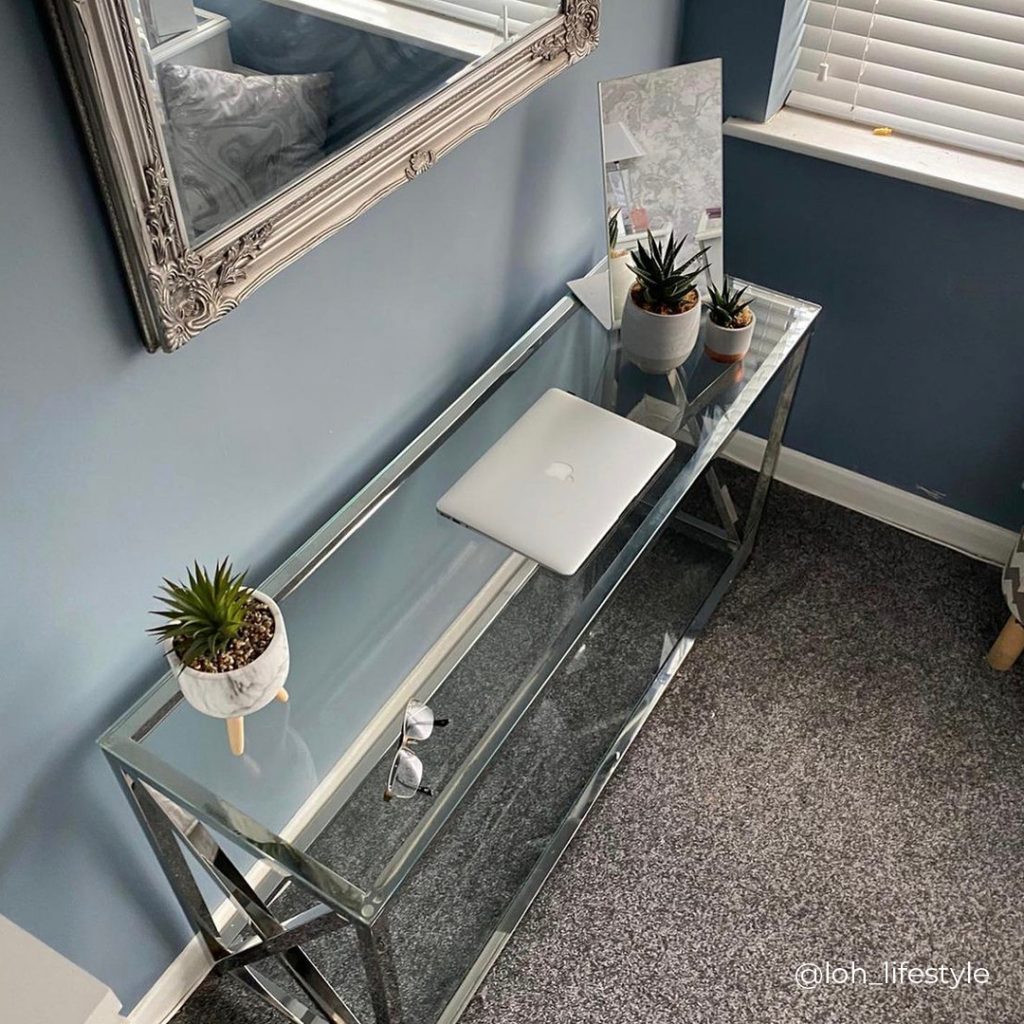 A console table being used as a slim home office desk, from above