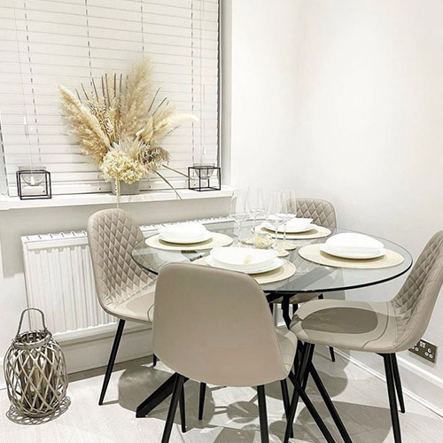 dininng room accessories - glass round dining table with grey beige chairs, neutral and natural accessories