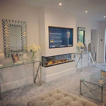 mirror ideas for living rooms - modern fireplace with tv above it on a chimney breast, with a console table and rectangular mirror in each alcove on either side of the chimney. 