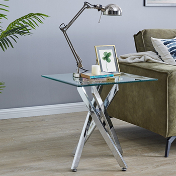A simple square glass console table on a living room, with reflective chrome legs. 