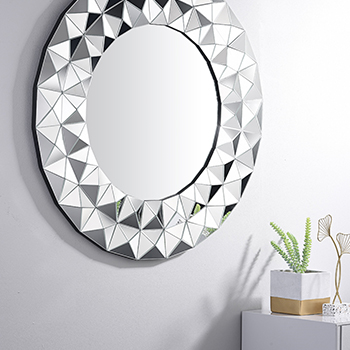 Furniturebox UK Luna mirror - round mirror in a mirrored frame with cut geometric pattern.