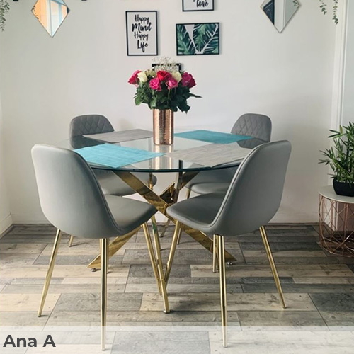 Customer image submitted by Ana A. Light, faded, rustic looking  floorbaords in a cream dining area, with round glass dining table on gold legs, and 4 grey faux leather chairs with gold legs. 