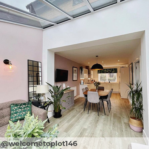 Instagram image from @welcometoplot146 featuring open plan dining area, with extension sun room living area. Pale but warm toned wooden flooring with a minimalist postmodern dining table ad 6 Pesaro grey velvet dining chairs from Furniturebox UK.