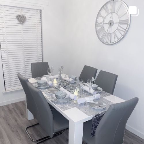 christmas instagram decor - grey dining room with white high gloss dining table 6 grey faux leater chairs, table runner set for christmas