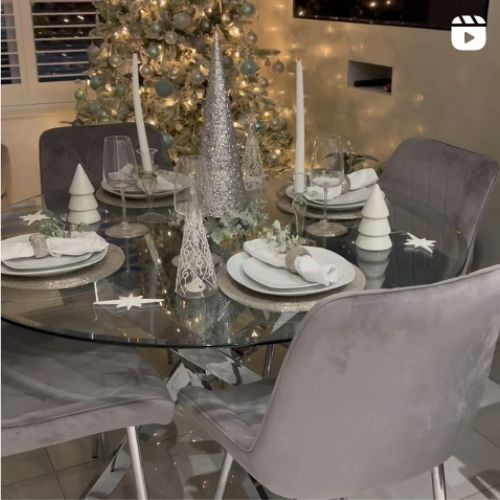 round glass dining table with 4 grey velvet chairs - styled for Christmas