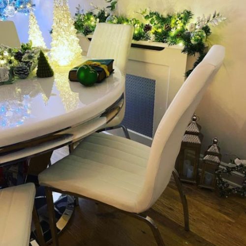 white and pale greenchristmas decor featuring round white high gloss and chrome dining table with white faux leather chairs for christmas decor inspiration