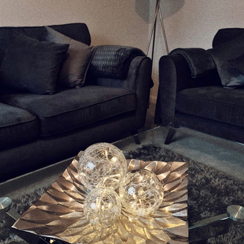 glass coffee table with silver metal geomtric palte, with 3 glass balls filled with fairy lights