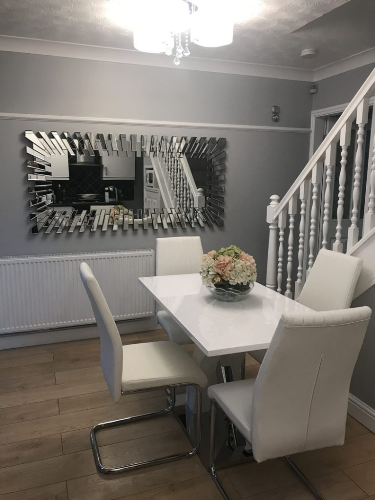 A rectangular Starburst mirror being used to reflect light in a hallway