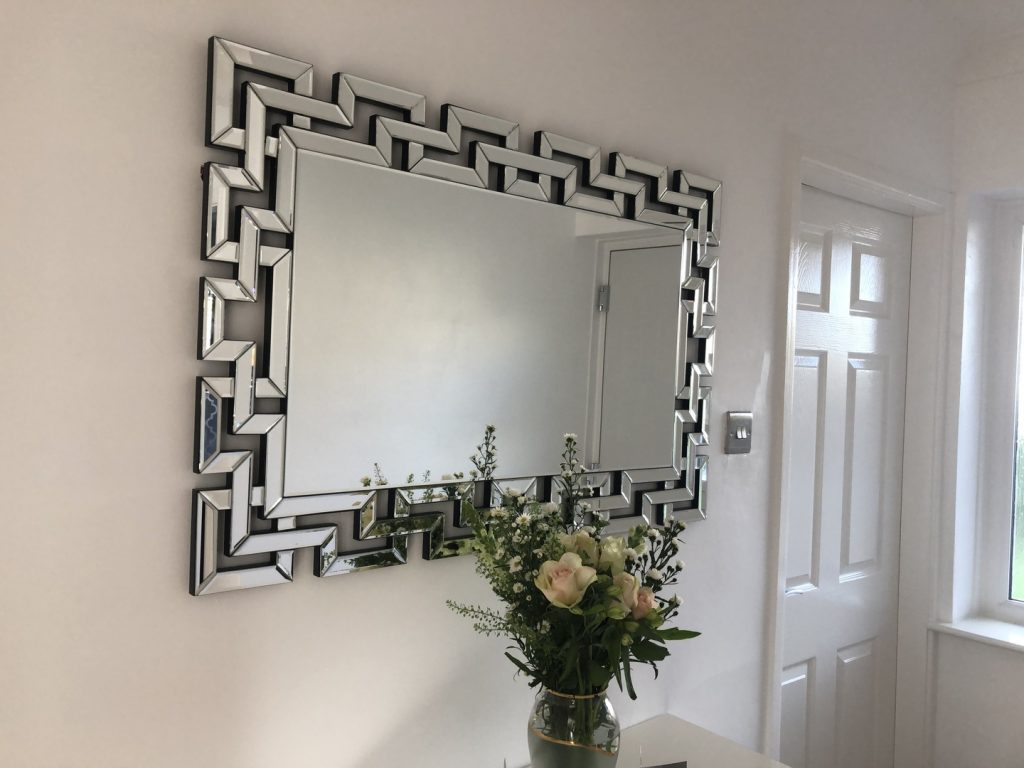 A Venetian mirror being used to brighten up a hallway