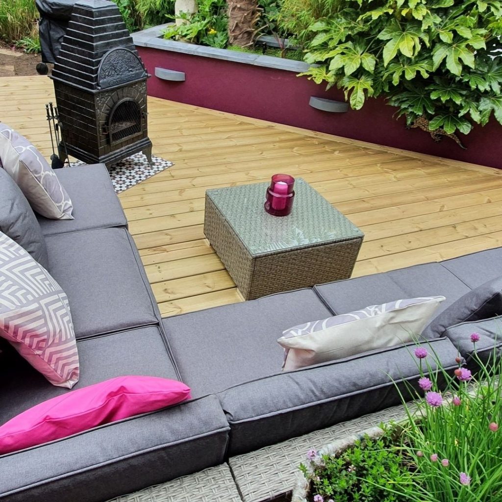 customer image of the Furniturebox UK Orlando rattan garden furniture set in grey styled with bright pink scatter cushions