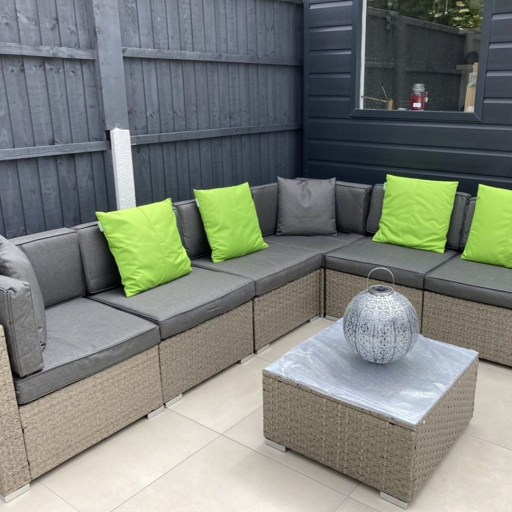 customer image of the Furniturebox UK Orlando rattan garden furniture set in grey styled with bright green scatter cushions