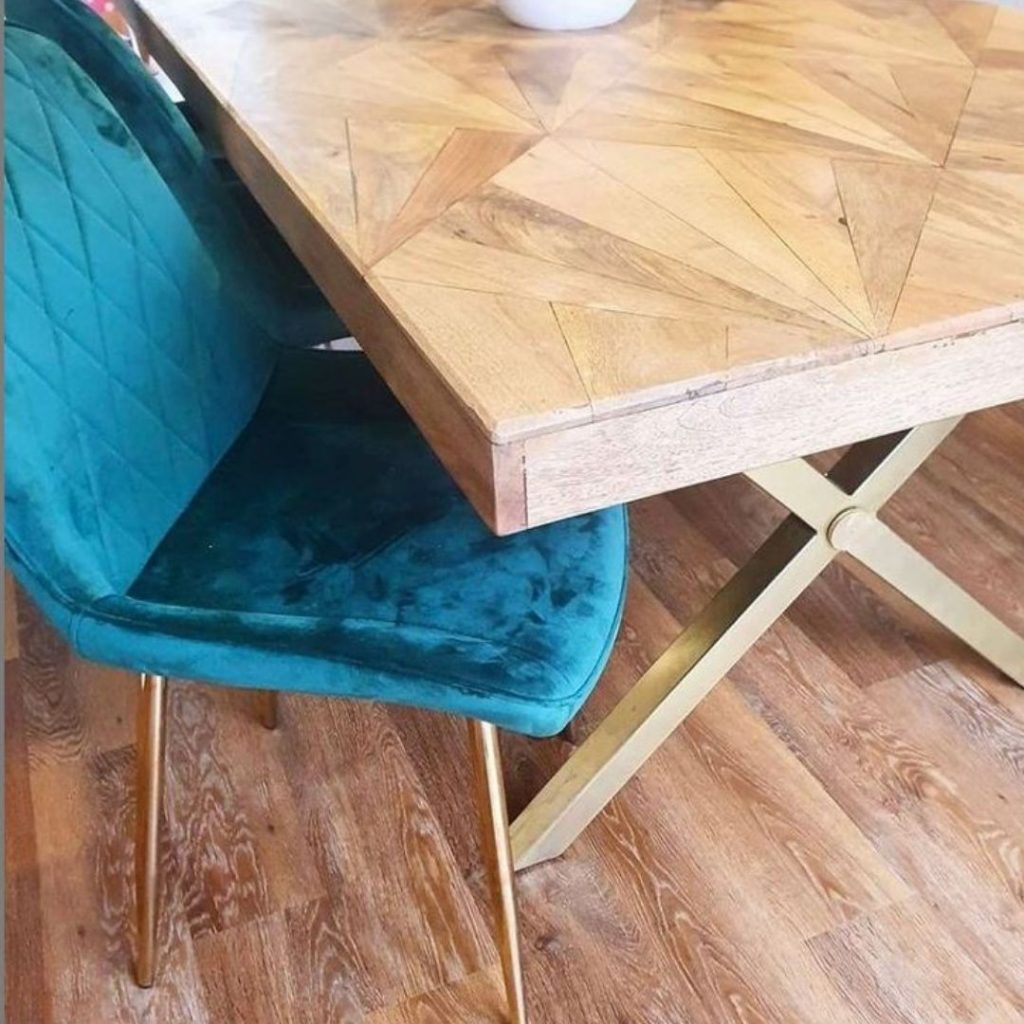 customer image featuring Furniturebox UK Taranto Oak dining table with gold geometric legs, and Pesaro velvet dining chair in teal, with gold legs.