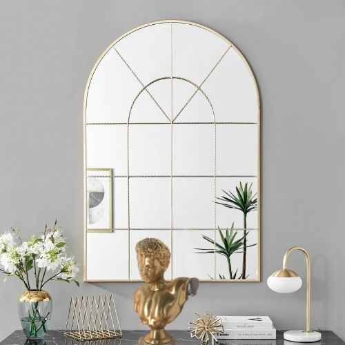large window style mirror in gold arch frame.