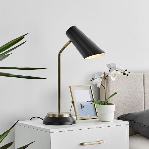 modern retro lamp on bedside table - black metal anglepoise lamp with tulip shaped shade, on gold thin stand.