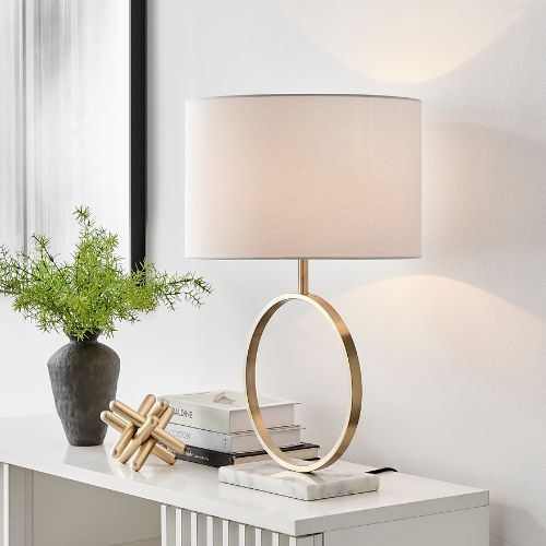 autumn lighting trends: modern table lamp - gold metal halo stand, marble base, oversized cream fabric lampshade