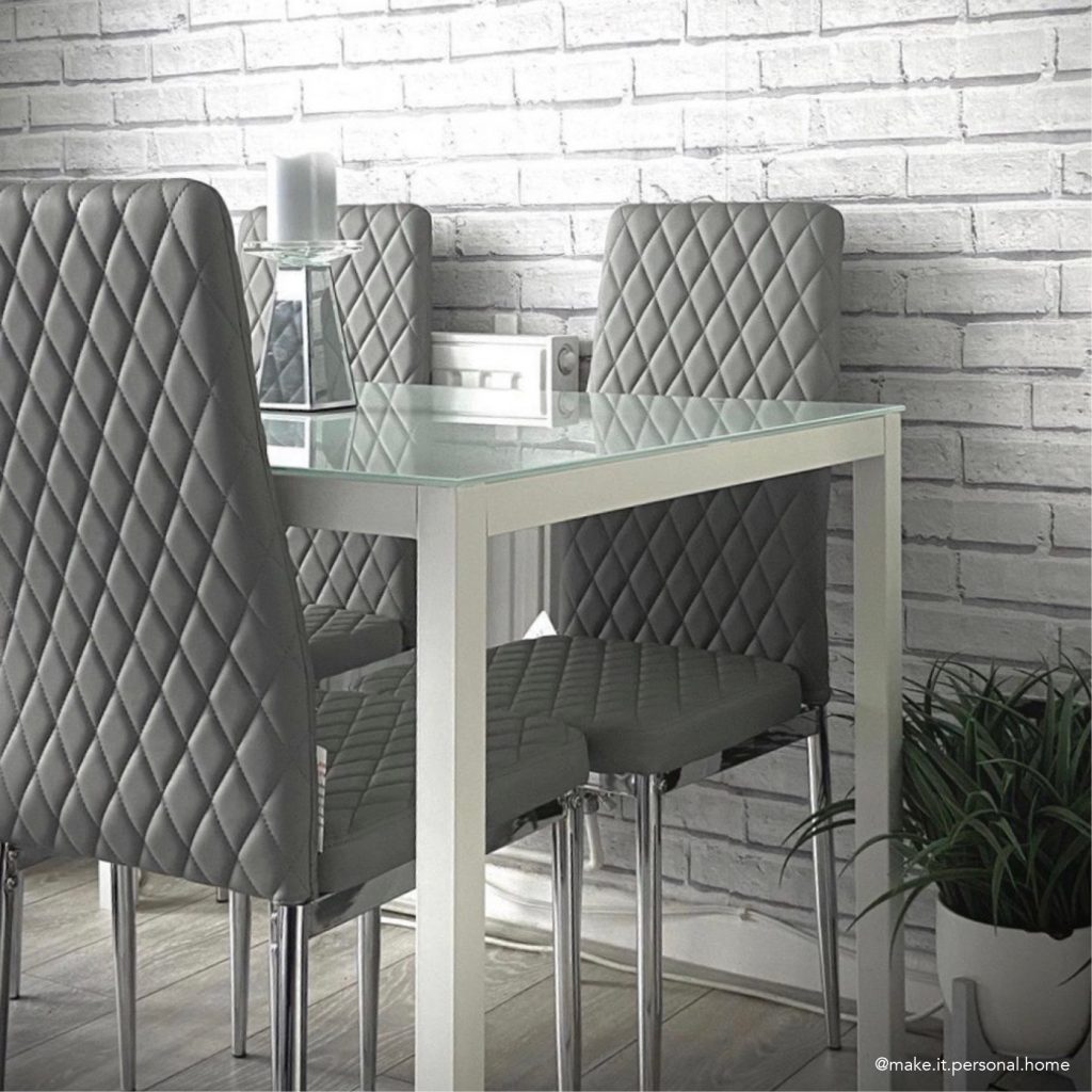 A white gloss rectangle dining table with faux leather luxury chairs