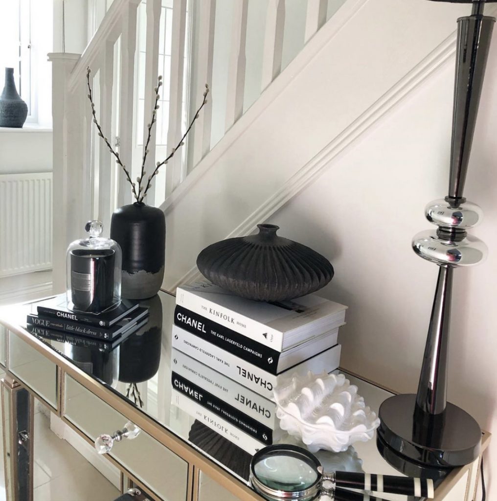 Chanel books and other decor on a hallway table