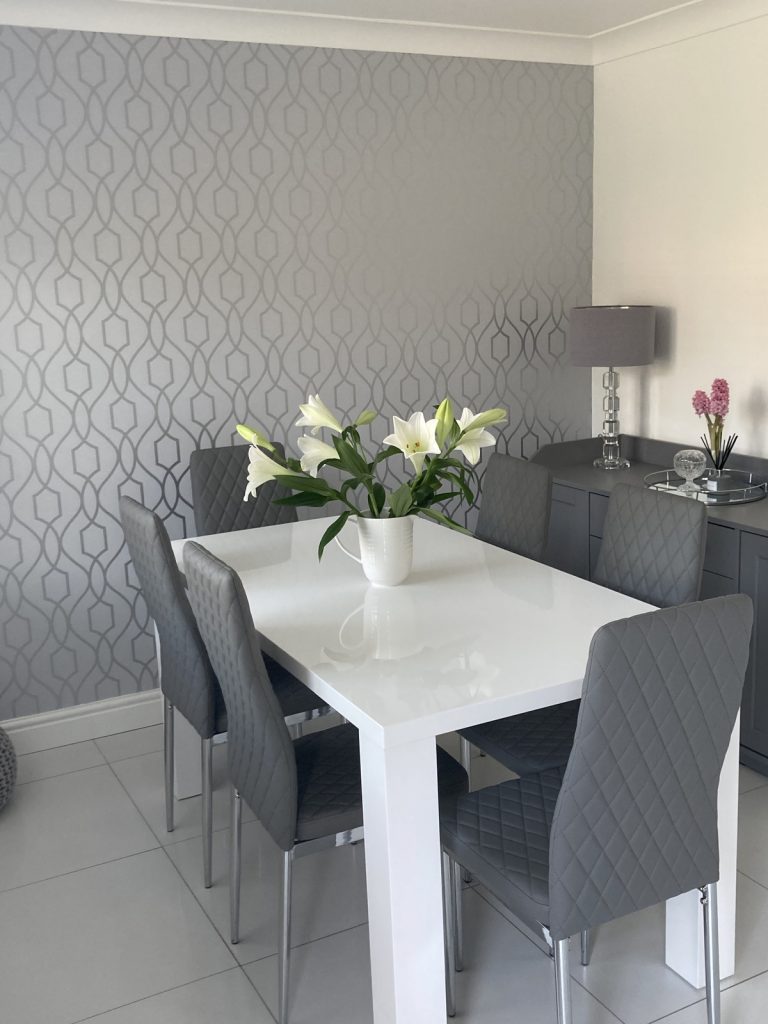 The Pivero table and Milan silver leg chairs alongside a feature wall