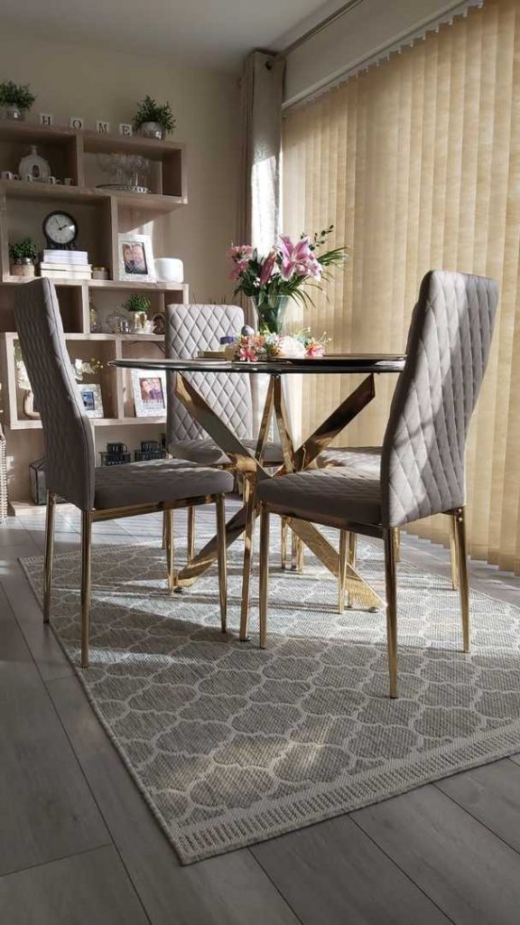 The Novara table paired with Milan chairs with gold legs