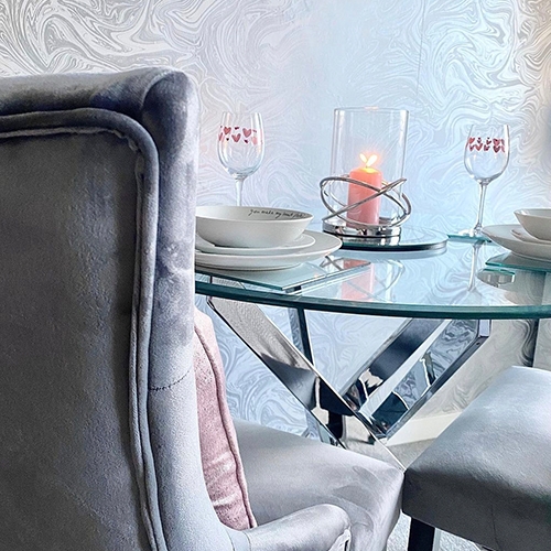 modern dining area with abstract wall paper featuring oil slick pattern in shades of grey, with slight oil metallic sheen. 