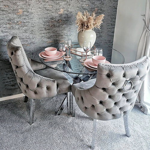 modern dining area with textured teree-bark like wall paper in shades of gey with patches of metallic rose gold. 