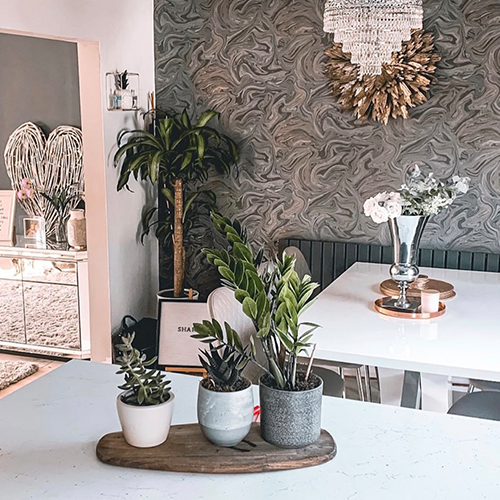 modern dining area with abstract wall paper featuring oil slick pattern in shades of grey, with slight oil metallic sheen. 