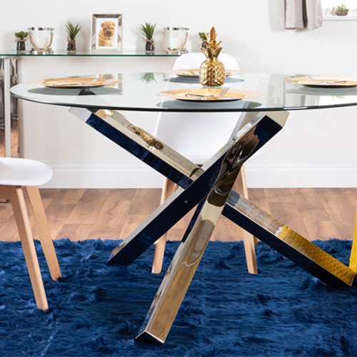 chrome leg dining table with a glass top on a navy blue rug