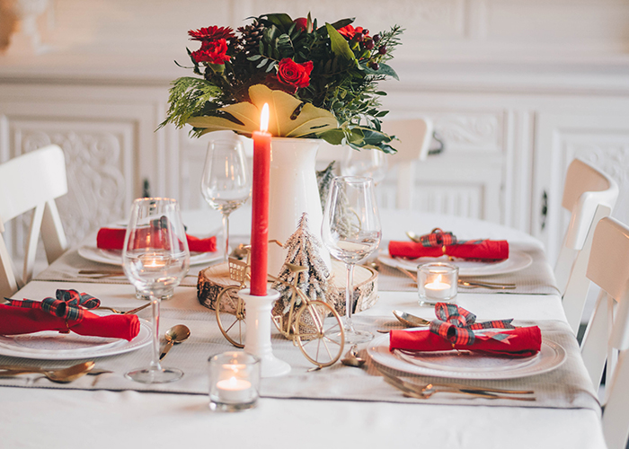 A white high gloss table decorated with red Christmas features