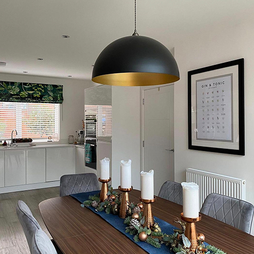 Instagram Christmas inspiration - modern dining area with table runner and 4 copper candle sticks with church candles