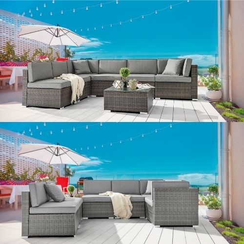 brown and grey rattan outdoor sofas on terrace decked area with parasol on summer day