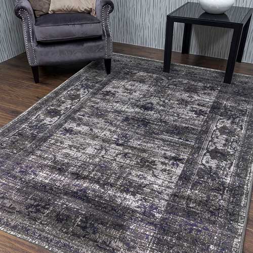 Grey and charcoal rug with vingate distressed pattern.