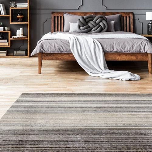 Artsy rug in textured stripes of grey, black and cream.