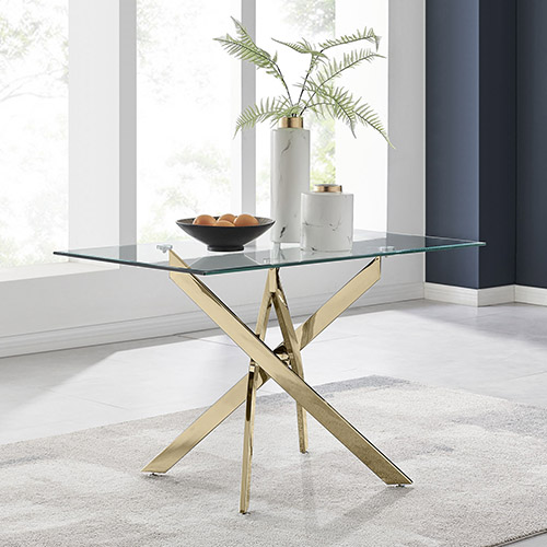 rectangular glass table with gold starburst nested legs in shiny metal.