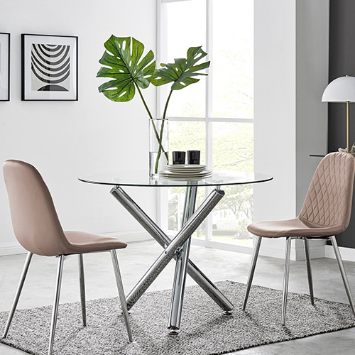 modern 2 seater dining table round glass table with silver chrome legs. 2 beige faux leather chairs with silver legs.