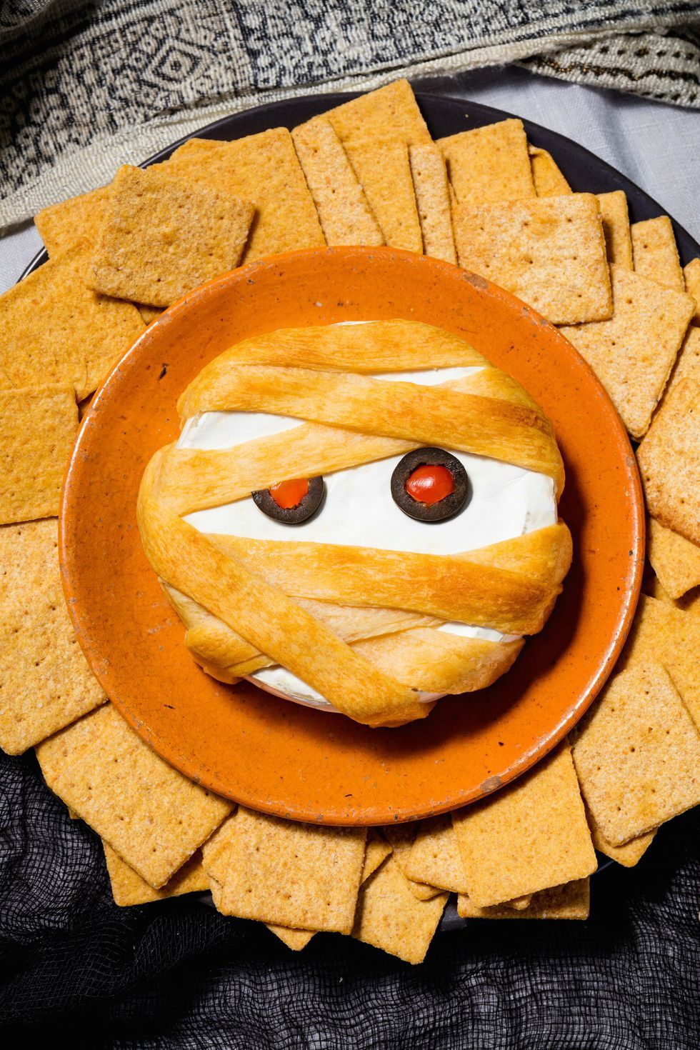 A mummy brie halloween party snack
