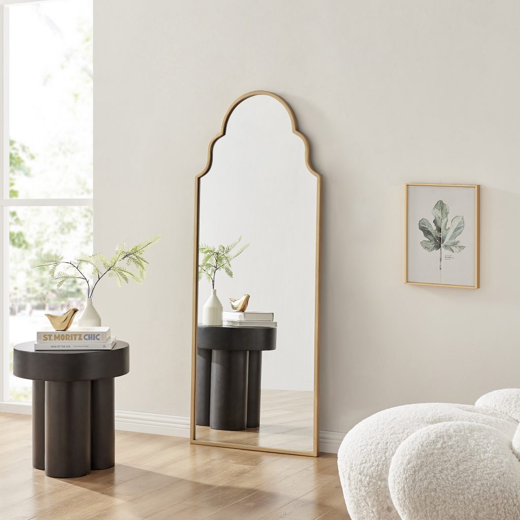 large gold framed mirror with Moroccan style decorative arched top in neutral living room
