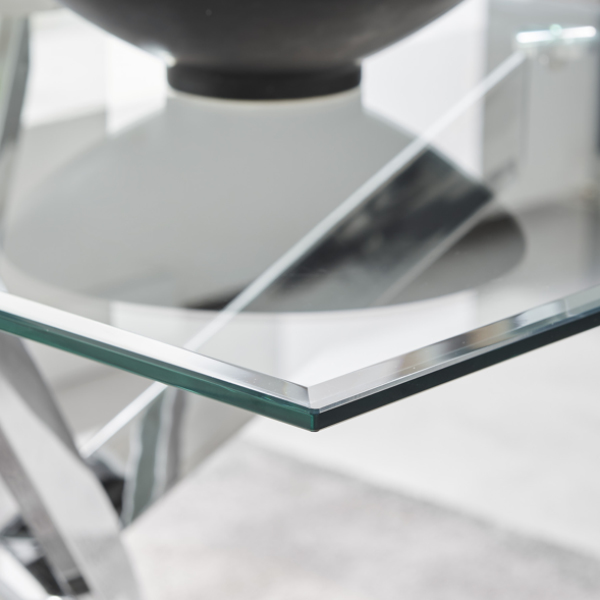 image shows the corner of a glass dining table up close