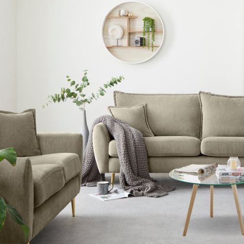 white living room with beige fabric sofas on tapered wooden legs with Scandi inspired round glass coffee table