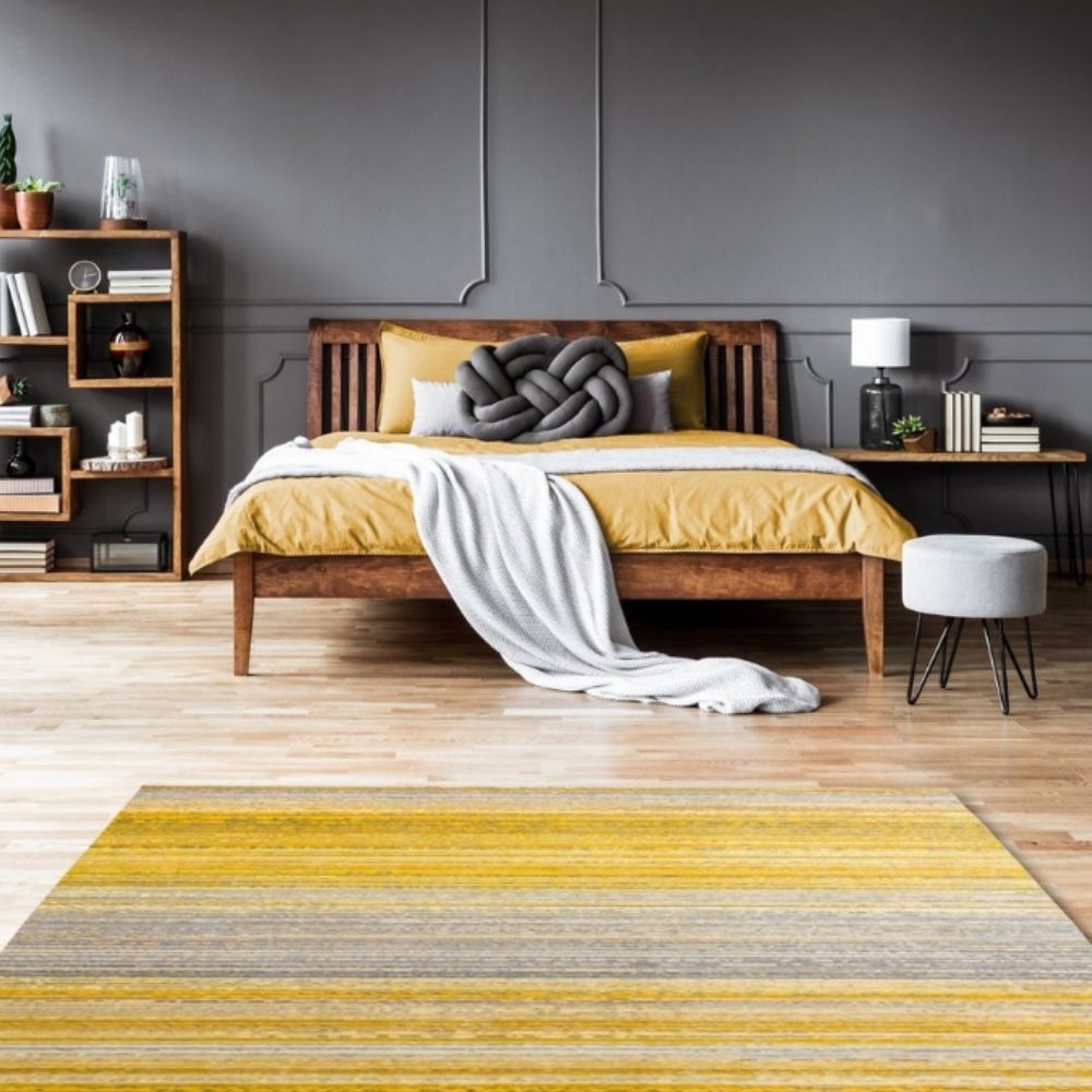 bedroom styling with wooden bed, yellow and grey linens