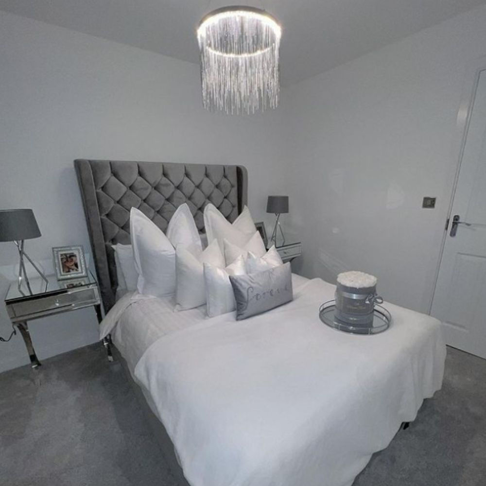 grey velvet bed with tall headboard in white and grey bedroom
