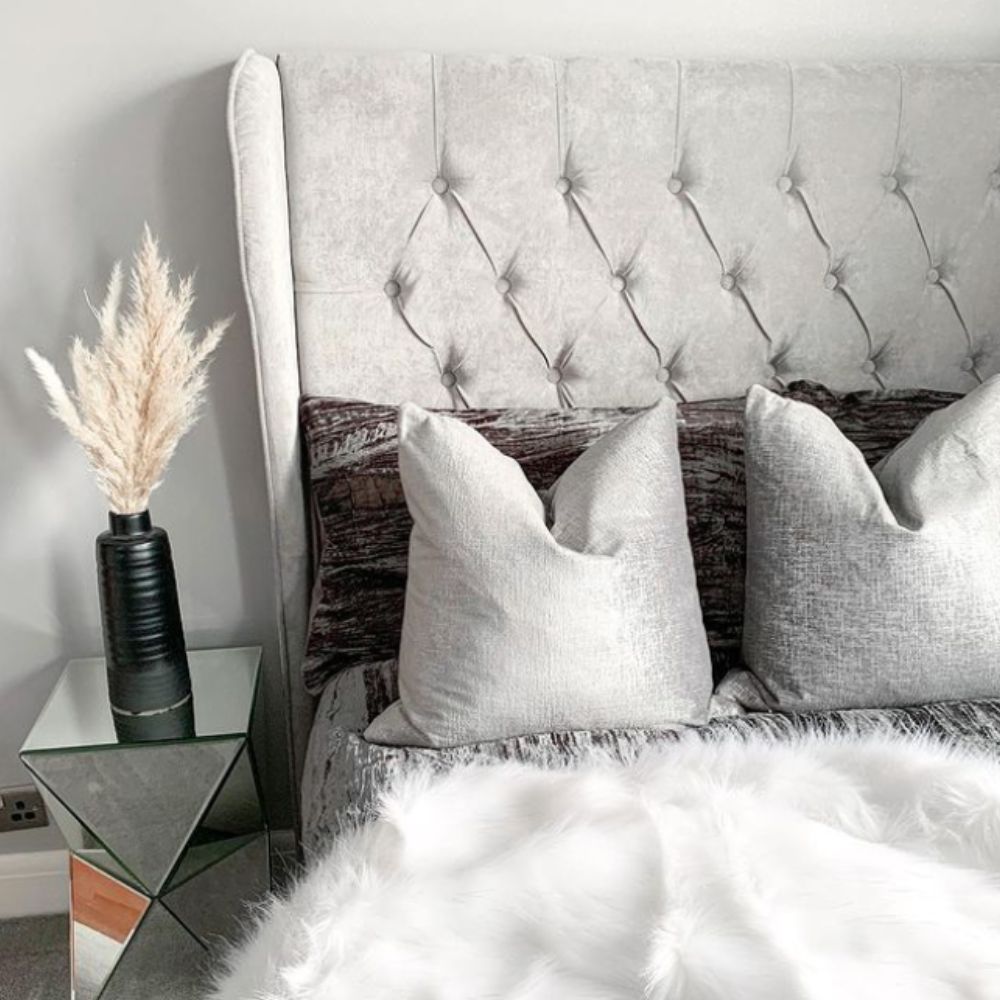 modern white and grey bedroom with velvet and fluffy bed furnishings