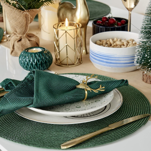 how to dress a table for christmas - close up of table settings with green and gold accents