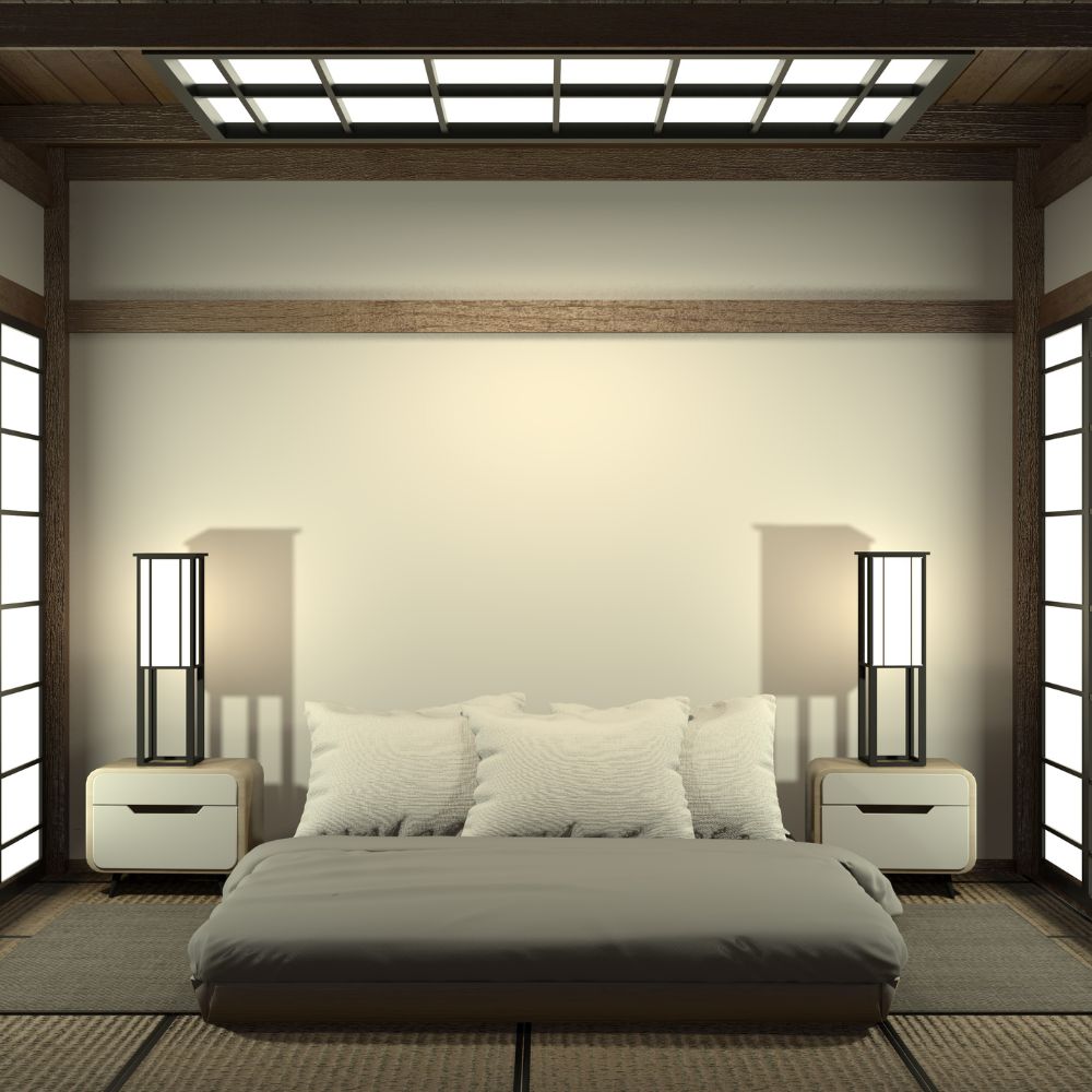 Japandi bedroom featuring curved bedsdie tables either ide of futon, with tatami rattan mats and black sliding doors