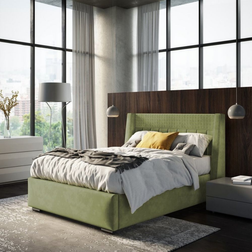 statement bed with tall headboard against wooden small partition wall, in a bright and airy Japandi-style room with black window frames. Bed is pale green velvet, with stone coloured linen and yellow cushion. 