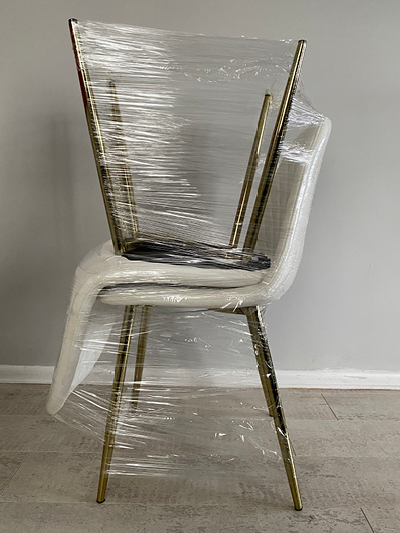 Two dining chairs wrapped together will help protect them when you're packing to move house.