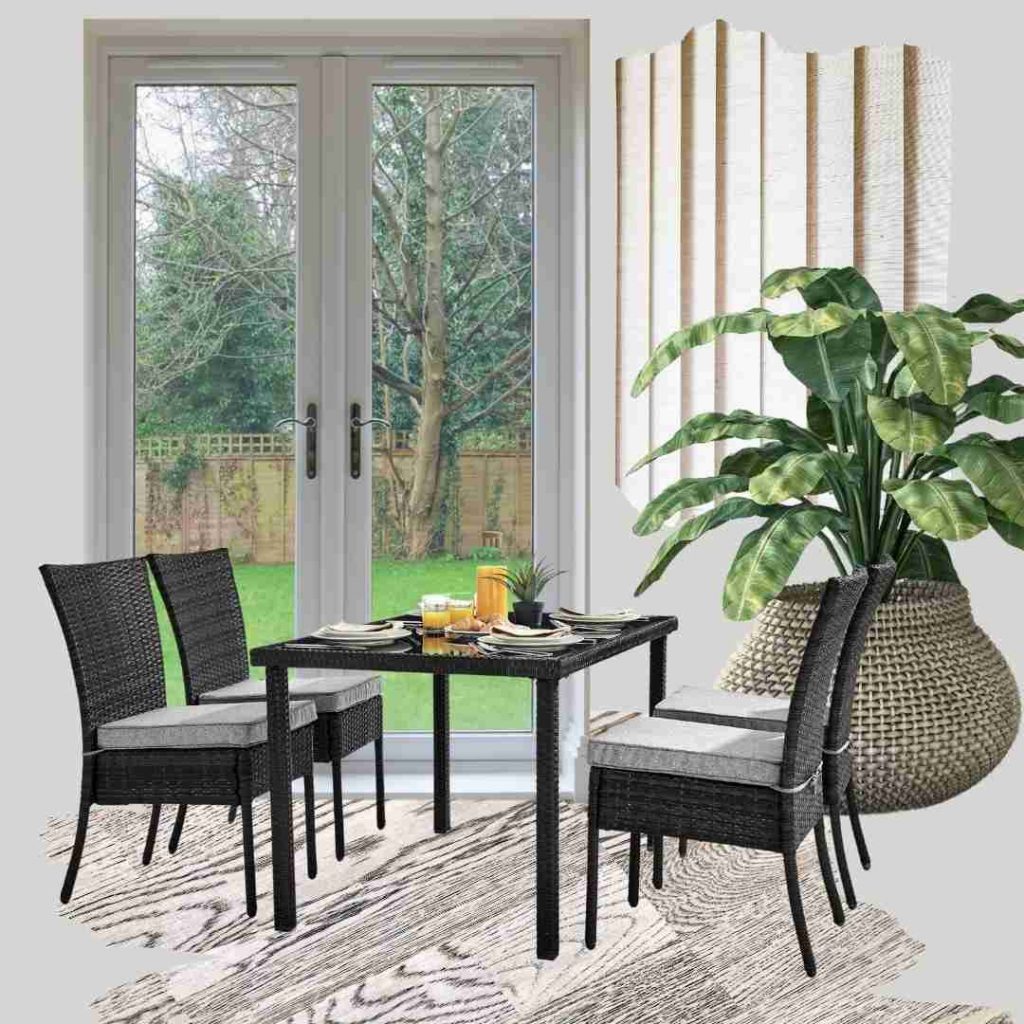 Simple 4 seater brown black garden dining set with 4 tall back chairs and a glass-topped table on pale ash with dark grain wood flooring, wicker plant holder with large leafy plant, white UPVC patio doors with garden view beyond and swatch of cream venetian blinds.