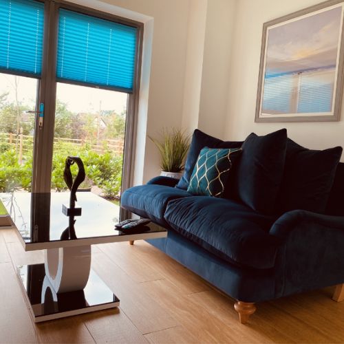 modern living space with black velvet sofa and statement high gloss coffee table