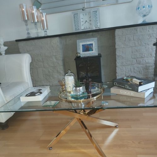 rectangular clear glass coffee table with shiny gold chrome metal legs in starburst nested arrangement,
